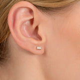 model wears petite solid 14k gold baguette cut white diamond stud earring