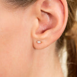 Model wears Minimalistic Gold earring stud with marquise Diamond