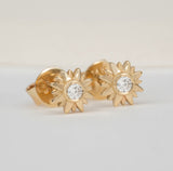 handmade pair of solid gold sunflower stud earrings with single diamond 