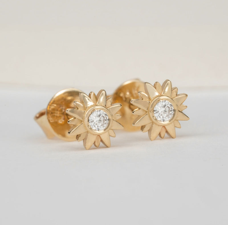 handmade pair of solid gold sunflower stud earrings with single diamond 