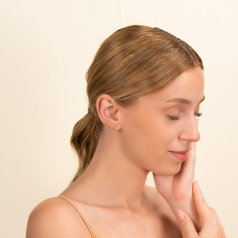 Model wears Dainty Solid Gold Hoop huggies in 3 sizes gift for her