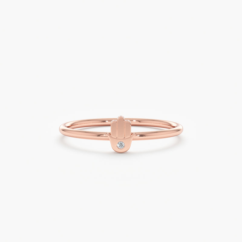 Rose gold hamsa ring with a single diamond