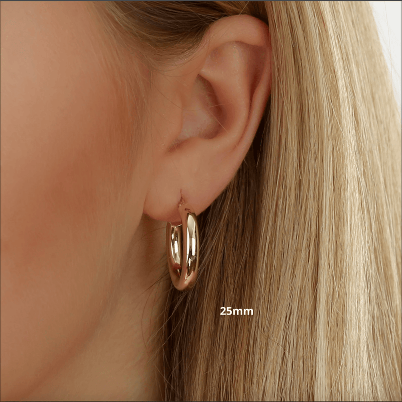 25mm thick gold hoop huggies in solid gold