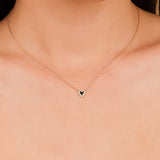 Two-tone heart necklace with black enamel and pave diamonds in solid gold.