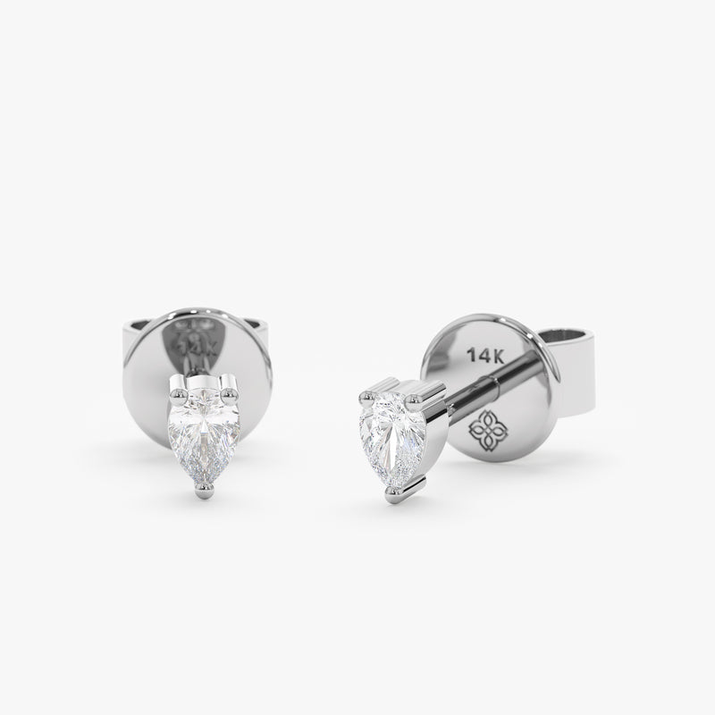 handcrafted pair of solid 14k white gold stud earrings with pear cut diamond
