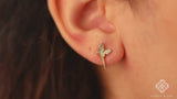 video close up of pair of solid gold diamond butterfly earring huggies