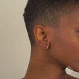 Video close up of model wearing Handmade Solid gold Earrings with three diamonds