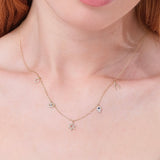 multiple protective charms necklace in solid gold with lined diamonds and blue sapphire