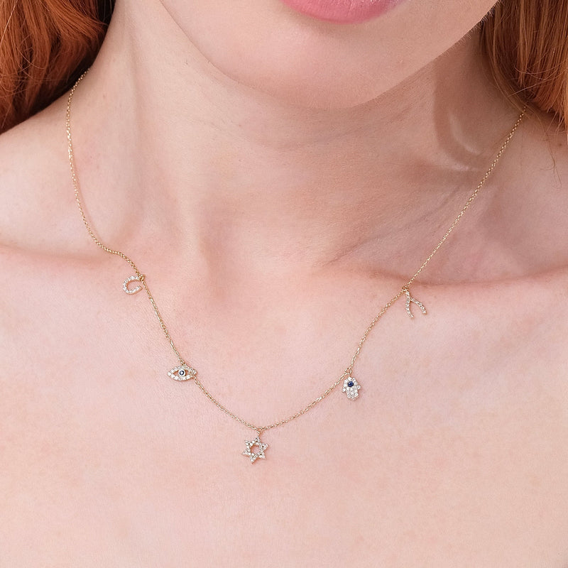 multiple protective charms necklace in solid gold with lined diamonds and blue sapphire