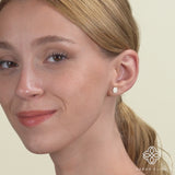 Video close up of model wearing solid 14k rose gold hamsa hand stud earrings with diamonds gift for her