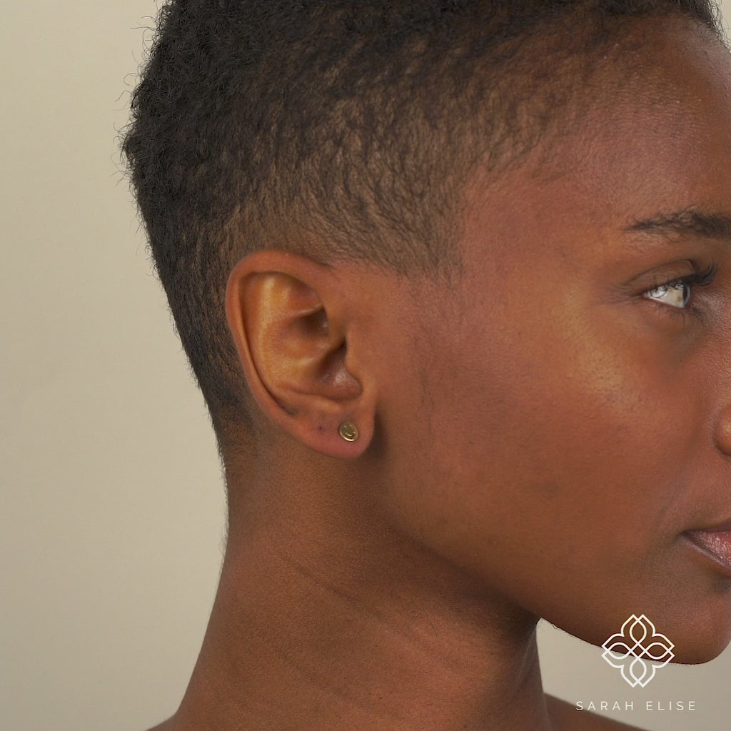 Model wears Solid Gold Happy Face Earrings for her
