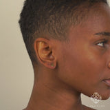 Model wears Solid Gold Happy Face Earrings for her