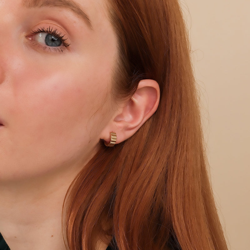 Model wears dainty gold grosgrain huggie earring gift for her